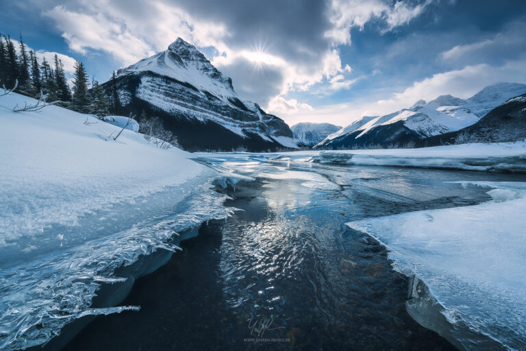Tangle Mountain / Peak in the Canadian Rocky Mountains in Jasper National Park with Beauty Creek and fantastic, razor-sharp ice formations in the soft wintry back light