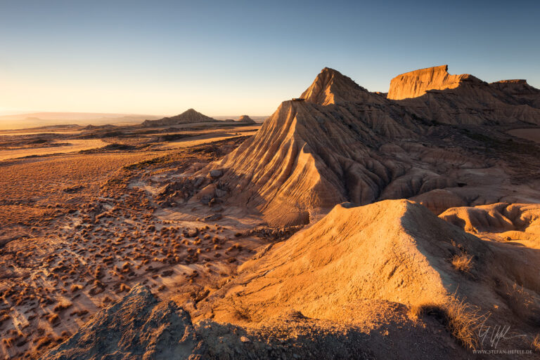 View from mountains in Bardena Reales desert at sunset in glistening light, Navarra, Spain
