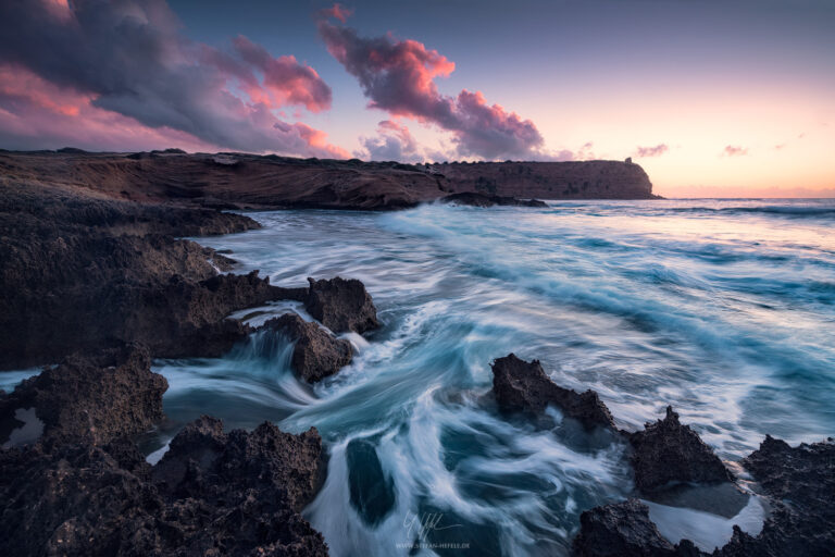 Sharp coastal scene in the violet sunset light on the Sinis peninsula on the Italian island of Sardinia