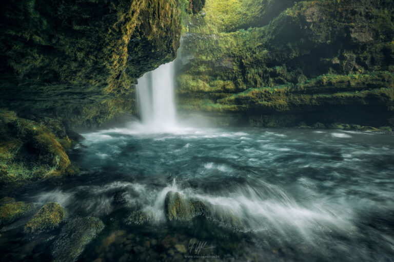 Like a mossy temple, the interior of Gluggafoss on Iceland presents itself in mystical shades of green