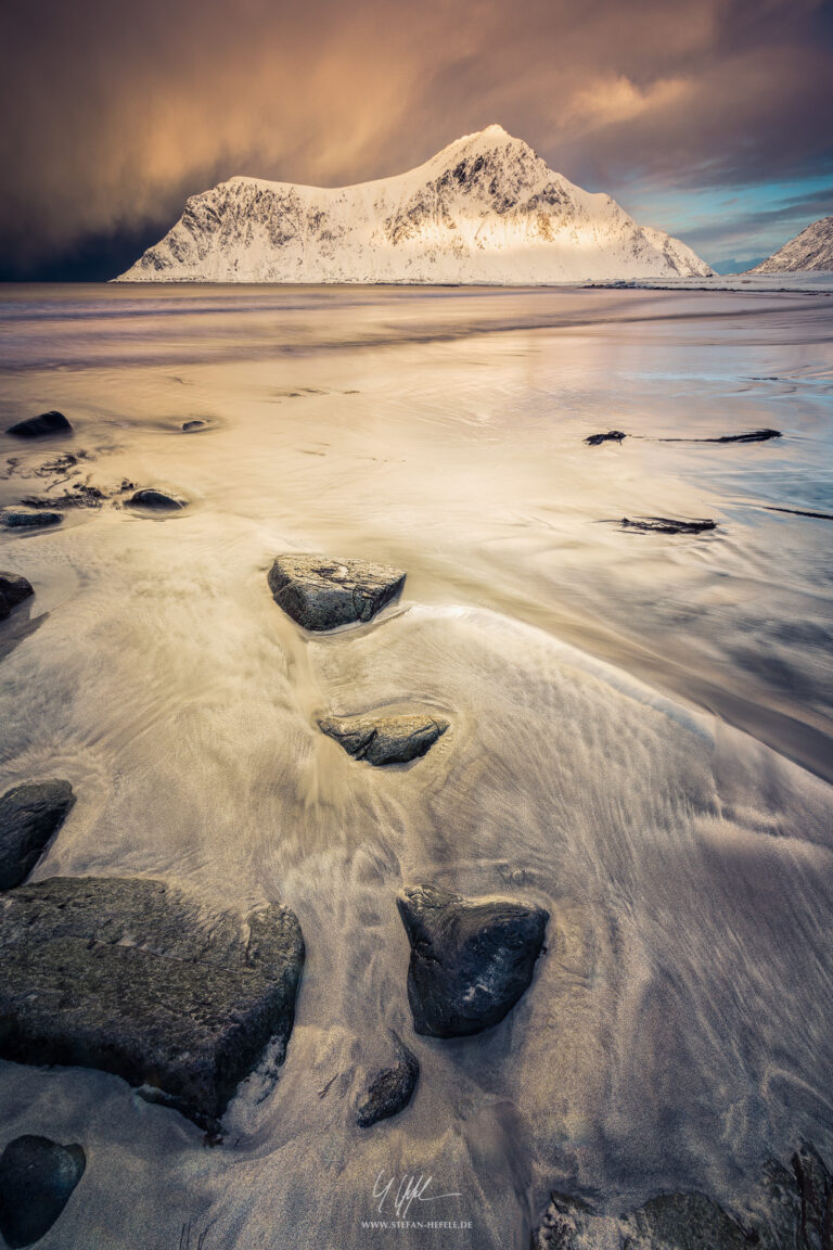 Golden light on Skagsanden beach in the Lofoten Islands in winter