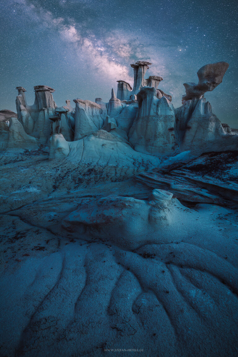 Bizarre rock formations in New Mexico, USA under the Milky Way in fairytale blue