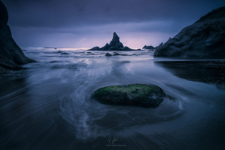 Shi Shi Beach in Olympic National Park iin Washington, USA, with rock needle in the twilight of a dark evening