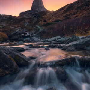 The Zervreilahorn in the Swiss Alps to the colourful sunset with rushing Bergback in the foreground