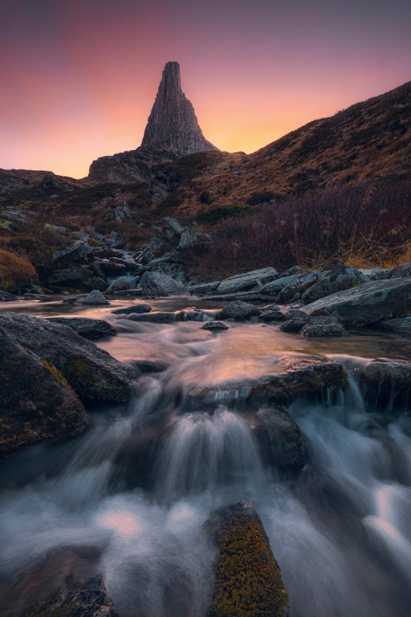 The Zervreilahorn in the Swiss Alps to the colourful sunset with rushing Bergback in the foreground