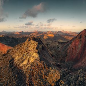 View into the volcanic maw of Montana del Senalo with Pico Partido in the background in the volcanic terrain of Lanzarote - NP Timanfayo - at sunset.
