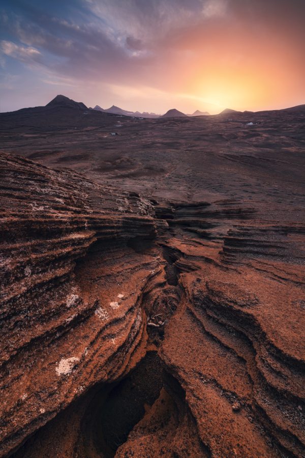 Volcanic landscape on Lanzarote at magnificent sunset photographed from Saga volcano with striking rock foregrounds