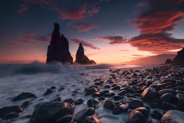 Seastack on the Atlantic island of Madeira in the colourful sunrise with splashing waves