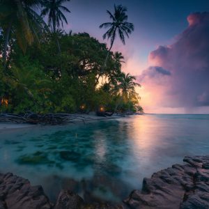 Adventurous and romantic coastal scene on a small tropical island in the North Nilandhe Atoll / Maldives in the magical twilight of the evening.