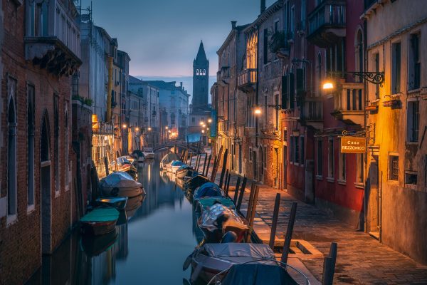 Romantic morning atmosphere on a canal in Venice with the old church of Saint Barnaba in the background