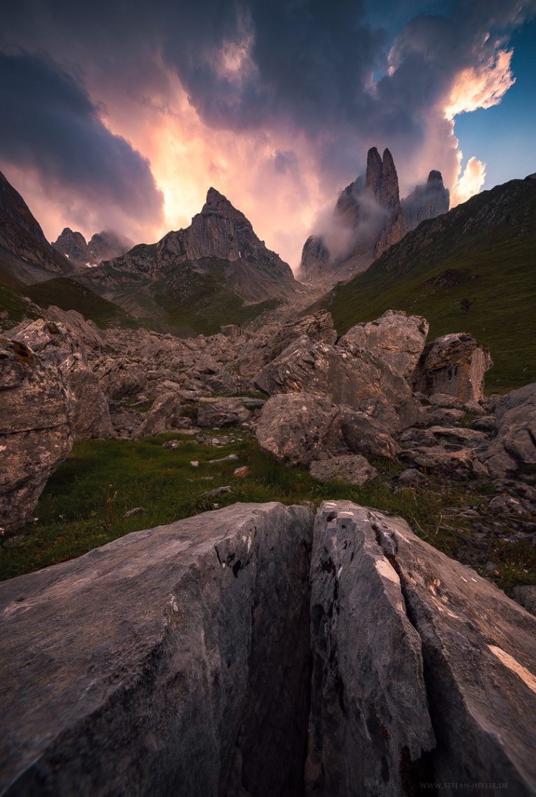 Aiguilles de Ansaberes in the French-Spanish border region in the Pyrenees in atmospheric summer thunderstorm light. Barren, rocky foreground